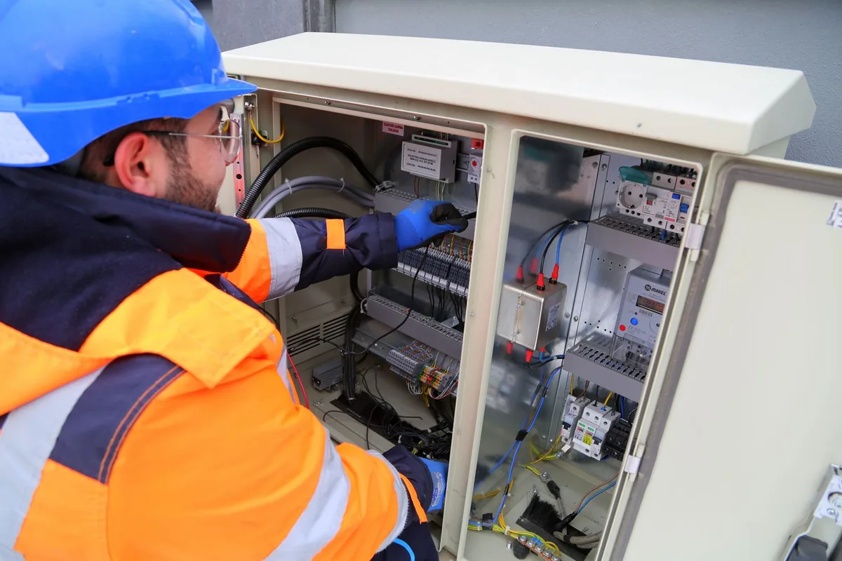 A technician servicing outdoor standby generator equipment at a Paramus, NJ property