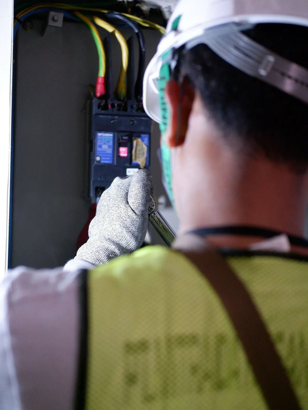 A technician checking generator breaker connections at a Peekskill, NY property