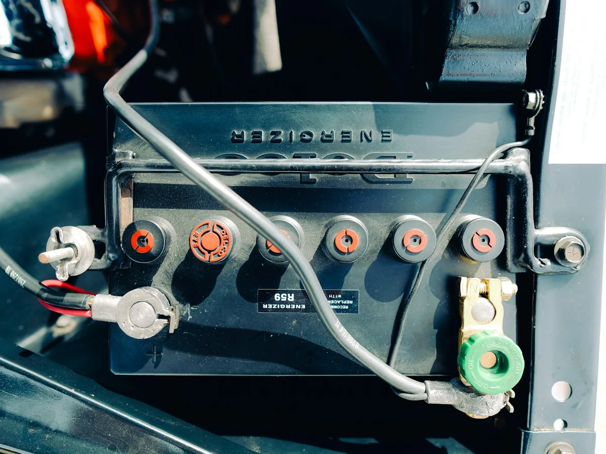 Technician connecting a new 12-volt battery to a Generac standby generator in Rockland County, NY