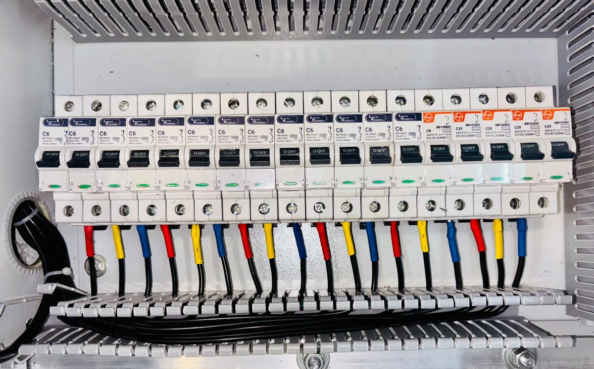 An electrician wiring an automatic transfer switch and electrical panel for a home standby generator in Rockland County, NY