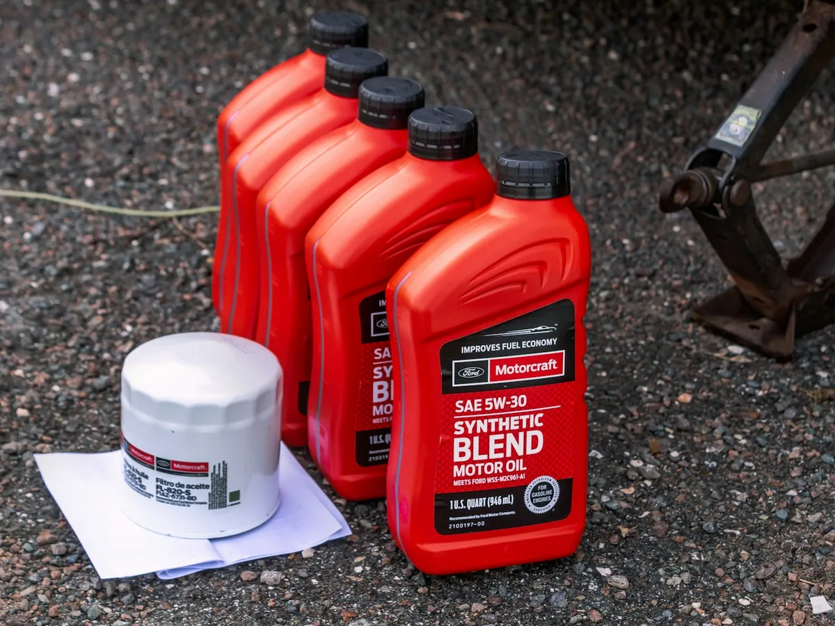 Fresh full-synthetic oil being poured into a Generac generator engine during a seasonal oil change in Rockland County, NY